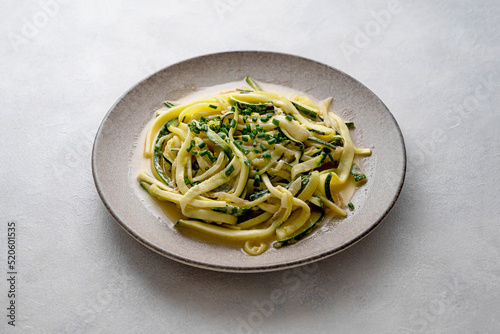 Zucchini courget spaghetti pasta with cheese, clean eating, vegan food, low carb healthy food photo