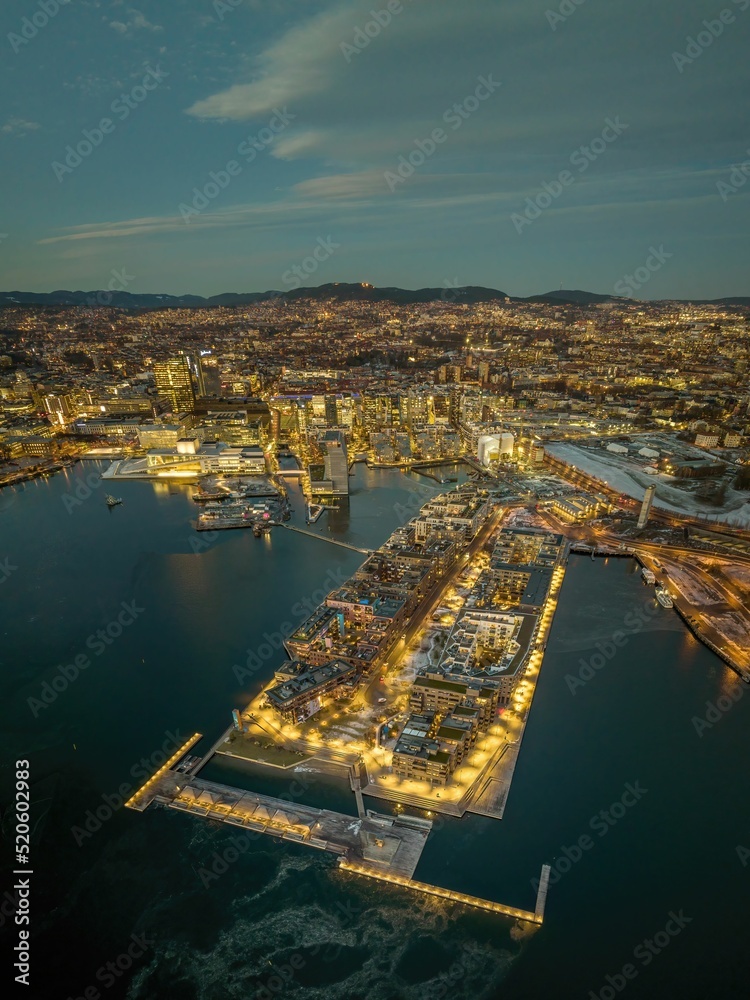 Obraz na płótnie Aerial shot of Oslo at sunset, with lots of buildings and lights, surrounded by sea, Norway w salonie