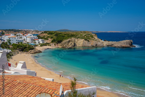 View of beach and rooftops in Arenal d'en Castell, Es Mercadal, Menorca, Balearic Islands, Spain
