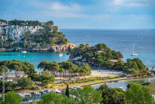 View of hotels overlooking marina and Mediterranean Sea in Cala Galdana, Cala Galdana, Menorca, Balearic Islands, Spain photo