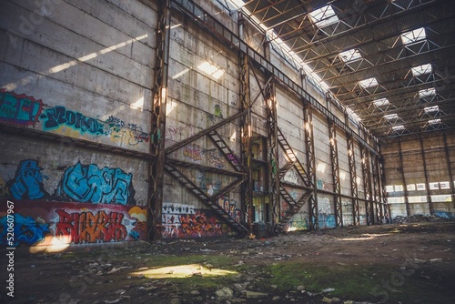 The sun's rays break through the roof of an abandoned warehouse 