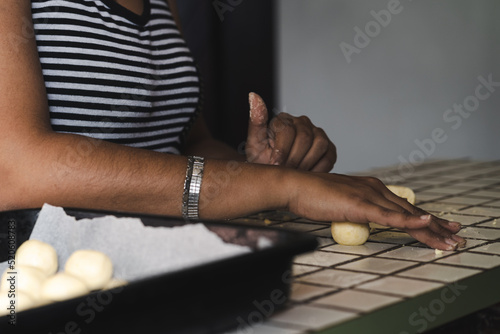 Latin woman making rolls for chipa, a traditional south american baked cheese bread made of cassava flour