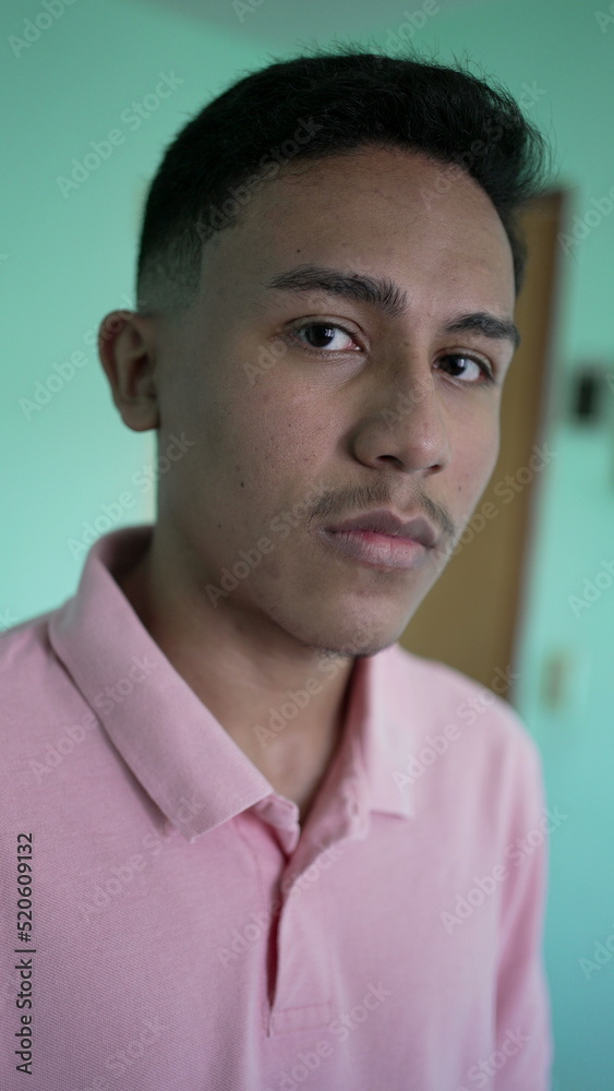 Portrait of a hispanic man looking at camera. A serious young latin person person Portrait of a hispanic man looking at camera. A serious young latin person person