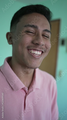 One young Brazilian man smiling at camera. A hispanic south american latin person