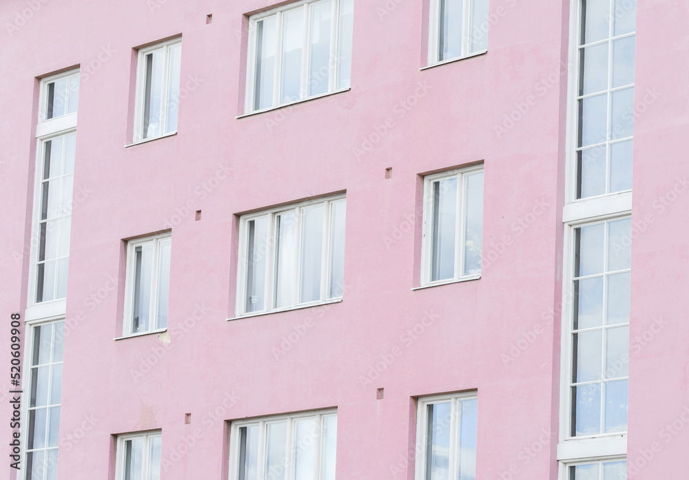 Pink apartment house wall with windows