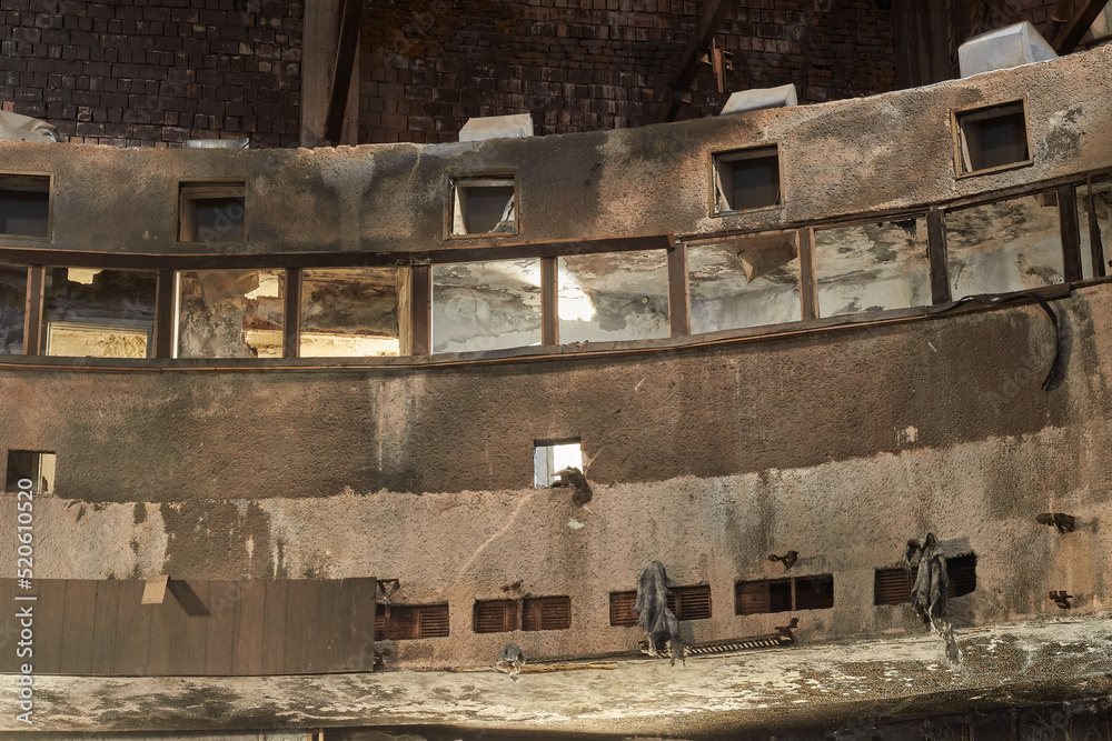 Fototapeta premium Abandoned ruined interior of the building. Old destroyed walls with garbage and dirt. 