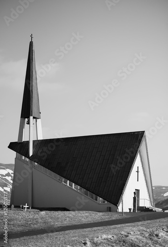 Vertical grayscale shot of a church in Mosfellsbaer, Iceland photo