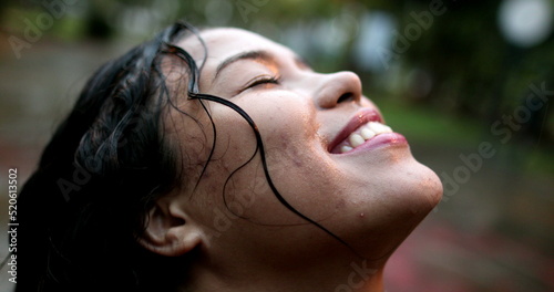 Photography Happy young woman in rain shower outside, girl enjoying the rain outdoors, close