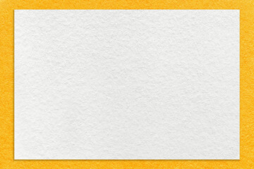 Texture of craft white color paper background with yellow border, macro. Vintage dense kraft orange cardboard
