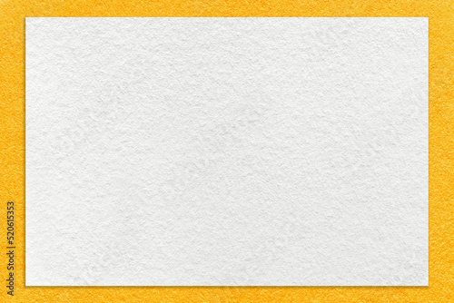 Texture of craft white color paper background with yellow border, macro. Vintage dense kraft orange cardboard
