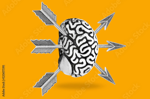 Photography Bow arrows sticking out of a human brain on yellow