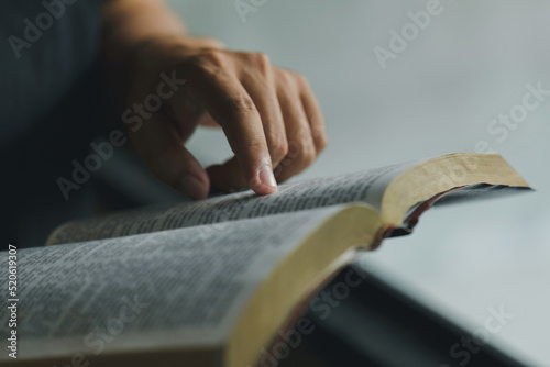 Stampa su tela Close-up of Christian man's hands while reading the Bible outside