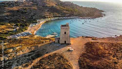 Aerial shot of Lippija tower on a shore of sea at sunset