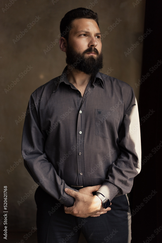 Attractive young man with a beard in a shirt Attractive young man with a beard in a shirt