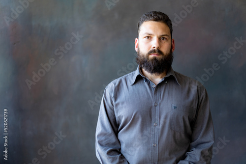 A young man with a beard on a gray background © Cavan