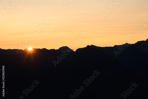 Sun Rising over British Columbia Mountain Horizon