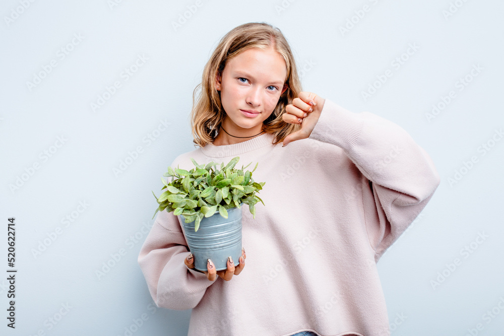 Caucasian teen girl holding a plant isolated on blue background feels proud and self confident, example to follow. Caucasian teen girl holding a plant isolated on blue background feels proud and self confident, example to follow.