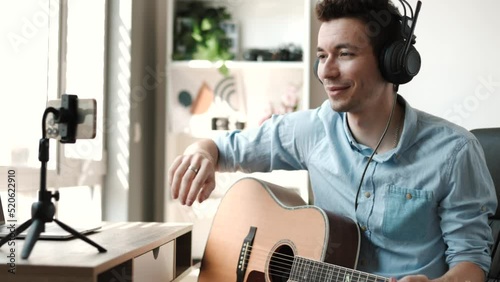 Guitarist making video lessons and tutorials for internet vlog website classes