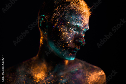 Portrait of a man painted in fluorescent UV colors.