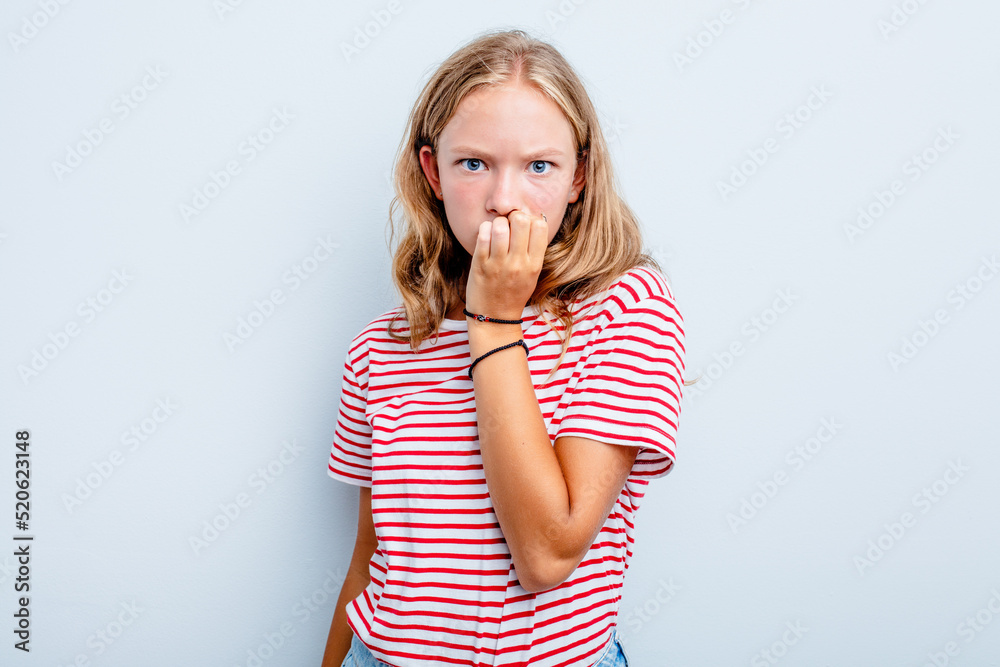 Caucasian teen girl isolated on blue background biting fingernails, nervous and very anxious. Caucasian teen girl isolated on blue background biting fingernails, nervous and very anxious.