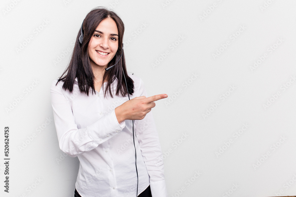 Telemarketer caucasian woman working with a headset isolated on white background smiling and pointing aside, showing something at blank space. Telemarketer caucasian woman working with a headset isolated on white background smiling and pointing aside, showing something at blank space.