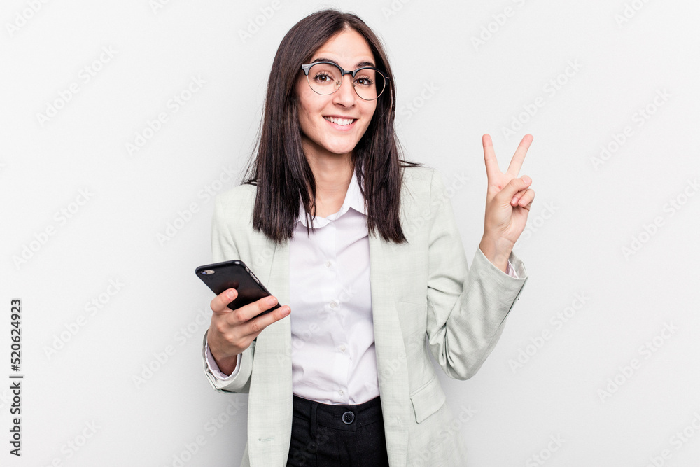 Young business caucasian woman holding mobile phone isolated on white background showing number two with fingers. Young business caucasian woman holding mobile phone isolated on white background showing number two with fingers.