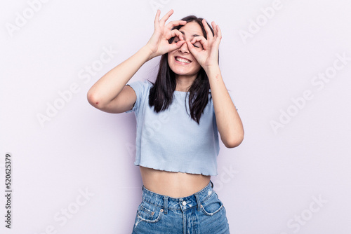 Young caucasian woman isolated on pink background excited keeping ok gesture on eye.
