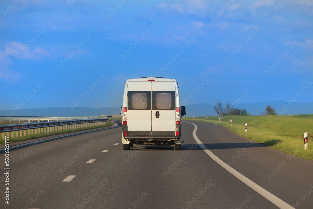 Mini bus moves along a suburban highway