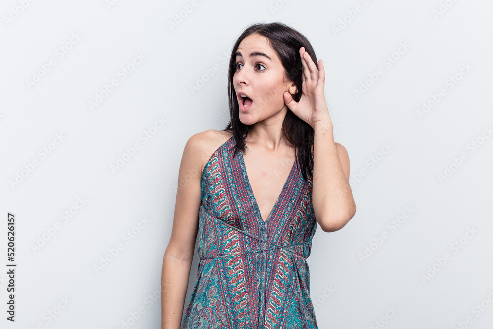 Young caucasian woman isolated on white background trying to listening a gossip. Young caucasian woman isolated on white background trying to listening a gossip.