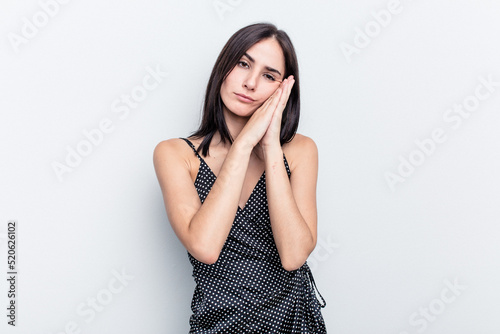 Young caucasian woman isolated on white background yawning showing a tired gesture covering mouth with hand.