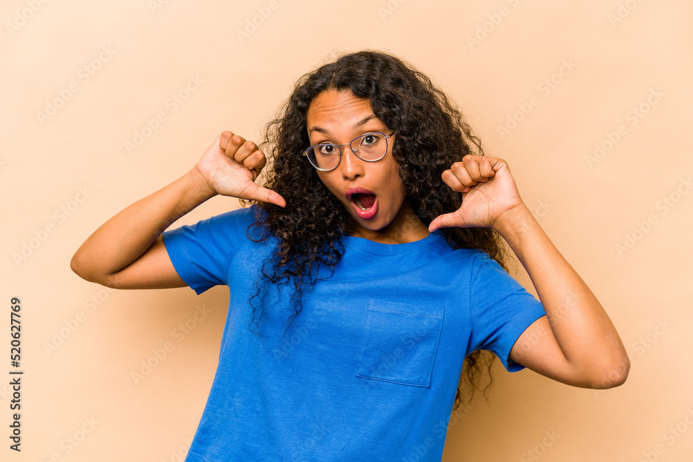 Young hispanic woman isolated on beige background feels proud and self confident, example to follow. Young hispanic woman isolated on beige background feels proud and self confident, example to follow.