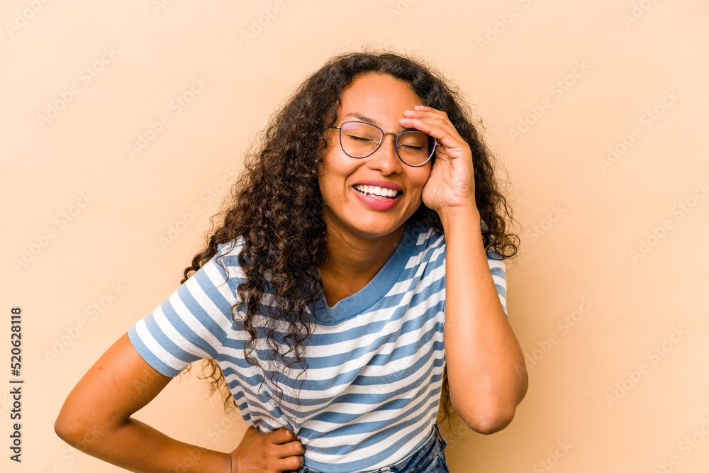Young hispanic woman isolated on beige background joyful laughing a lot. Happiness concept. Young hispanic woman isolated on beige background joyful laughing a lot. Happiness concept.