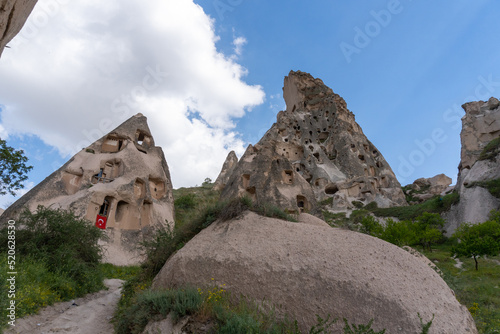 Landscape of Uchisar in Cappadocia, with the typical houses on the rocks, on a day with many clouds in the sky