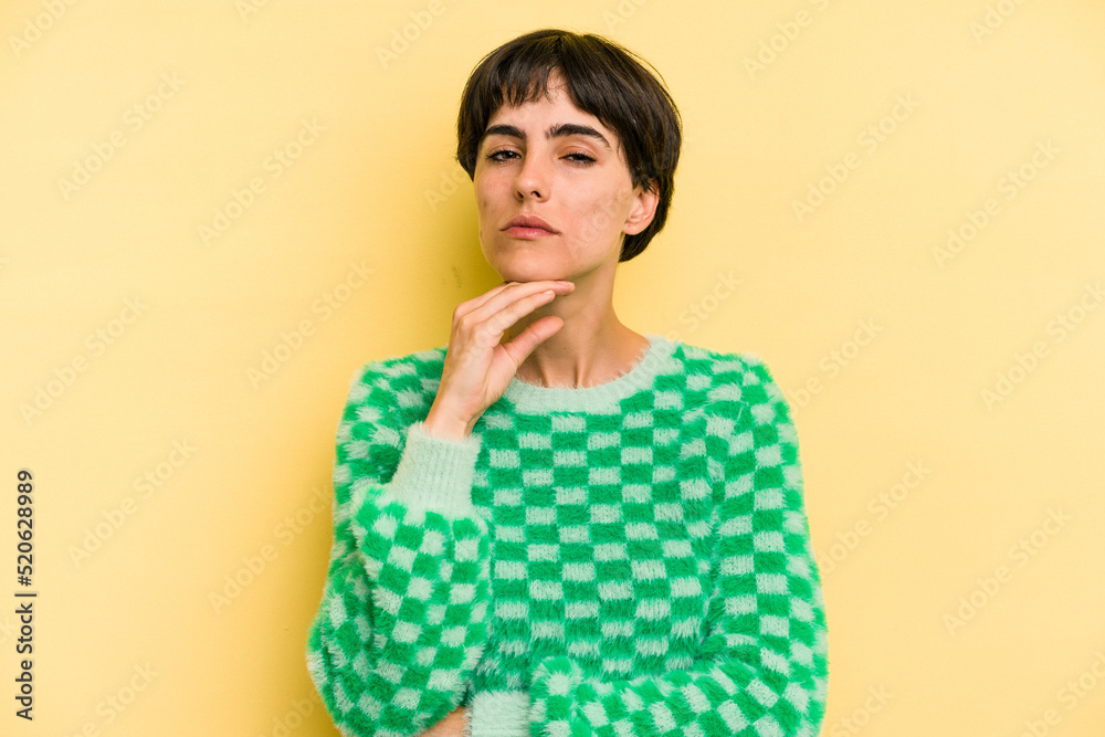 Young caucasian woman with a short hair cut isolated suspicious, uncertain, examining you. Young caucasian woman with a short hair cut isolated suspicious, uncertain, examining you.