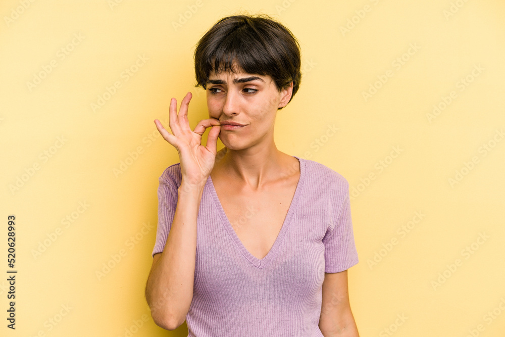 Young caucasian woman with a short hair cut isolated with fingers on lips keeping a secret. Young caucasian woman with a short hair cut isolated with fingers on lips keeping a secret.