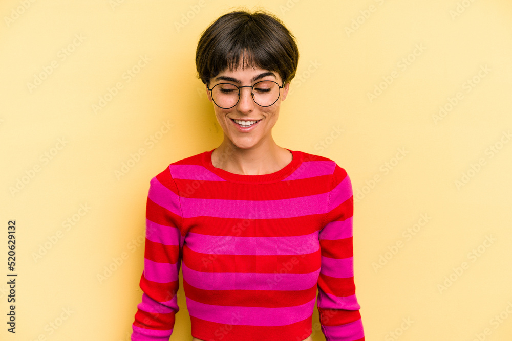 Young caucasian woman with a short hair cut isolated laughs and closes eyes, feels relaxed and happy. Young caucasian woman with a short hair cut isolated laughs and closes eyes, feels relaxed and happy.