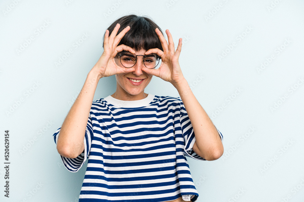 Young caucasian woman with a short hair cut isolated showing okay sign over eyes Young caucasian woman with a short hair cut isolated showing okay sign over eyes