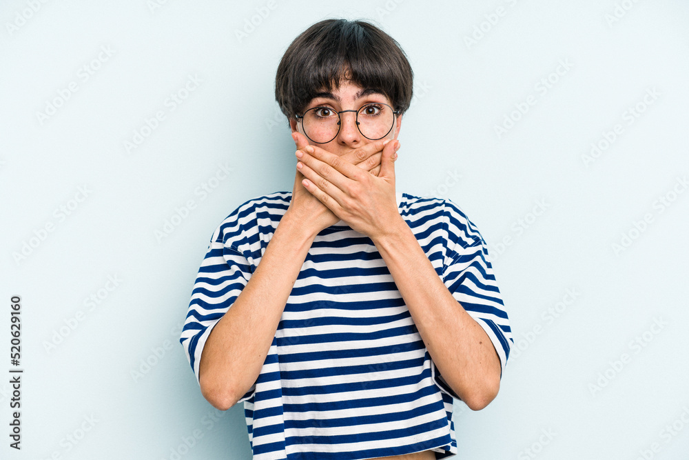 Young caucasian woman with a short hair cut isolated covering mouth with hands looking worried. Young caucasian woman with a short hair cut isolated covering mouth with hands looking worried.