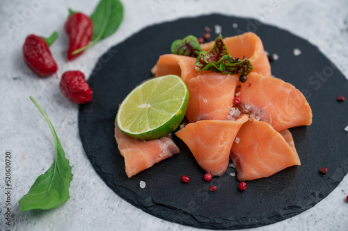 Fresh salmon slices with pe...