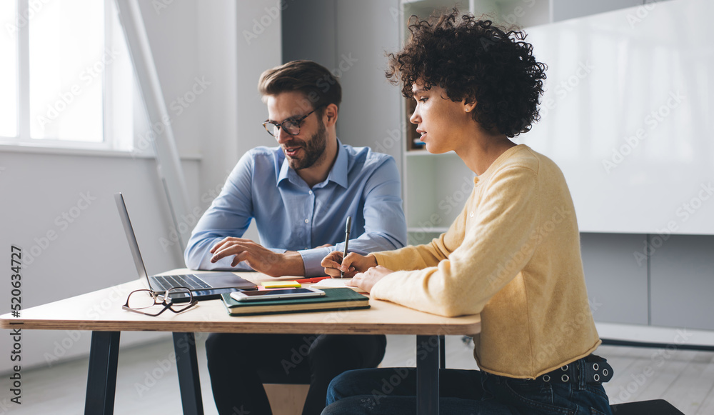 Millenial business man and woman working in office Millenial business man and woman working in office