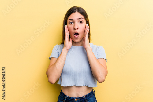 Young caucasian woman isolated on yellow background surprised and shocked.