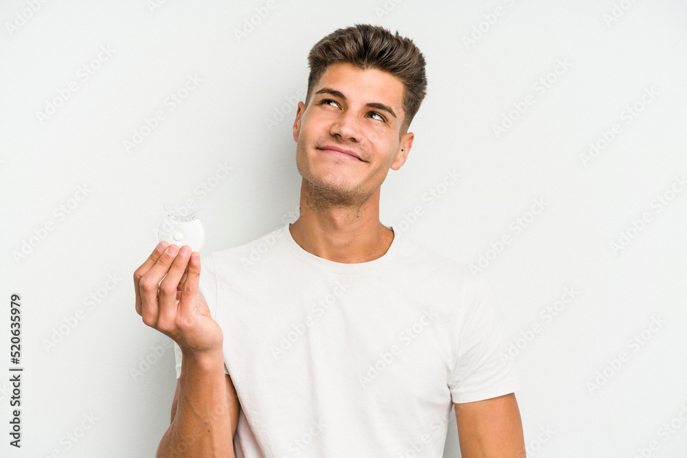 Young caucasian man hand sling isolated on white background dreaming of achieving goals and purposes Young caucasian man hand sling isolated on white background dreaming of achieving goals and purposes