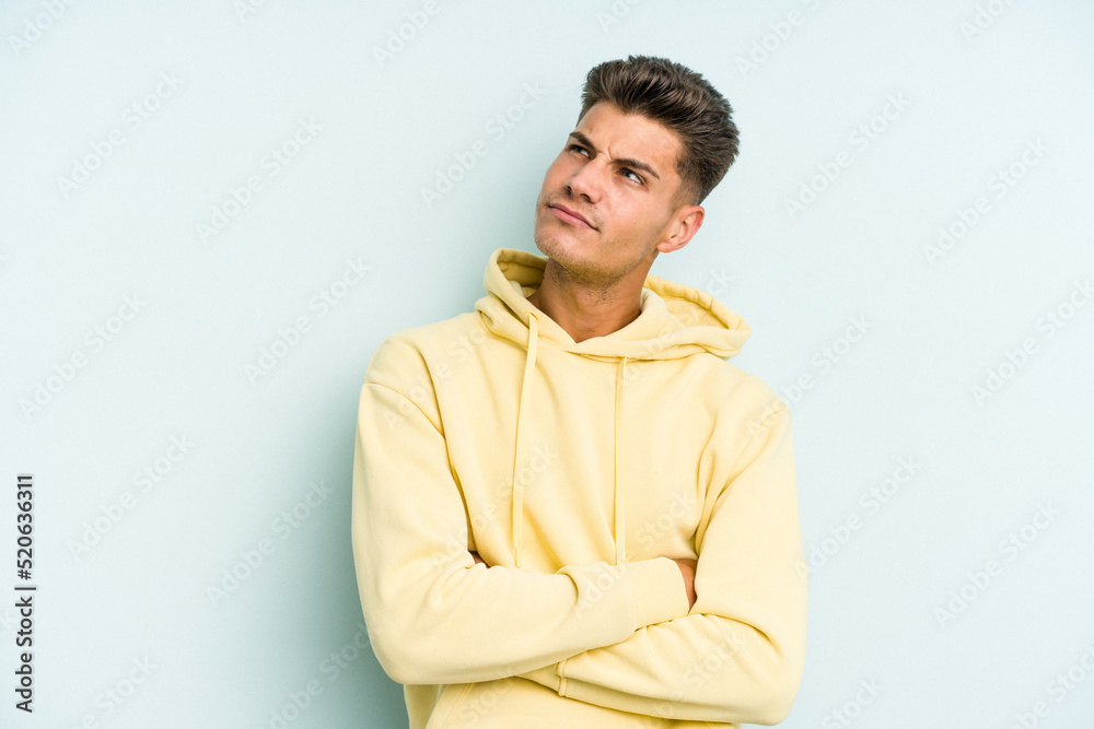 Young caucasian man isolated on blue background dreaming of achieving goals and purposes Young caucasian man isolated on blue background dreaming of achieving goals and purposes