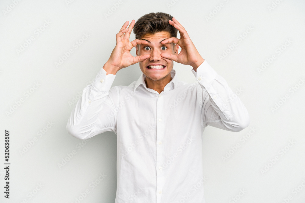 Young caucasian man isolated on white background keeping eyes opened to find a success opportunity. Young caucasian man isolated on white background keeping eyes opened to find a success opportunity.