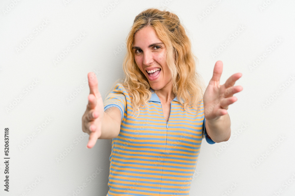 Young caucasian woman isolated on white background feels confident giving a hug to the camera. Young caucasian woman isolated on white background feels confident giving a hug to the camera.