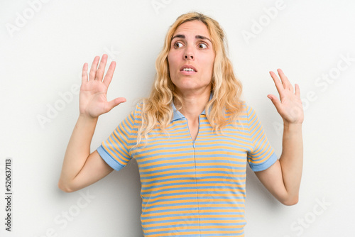 Young caucasian woman isolated on white background being shocked due to an imminent danger