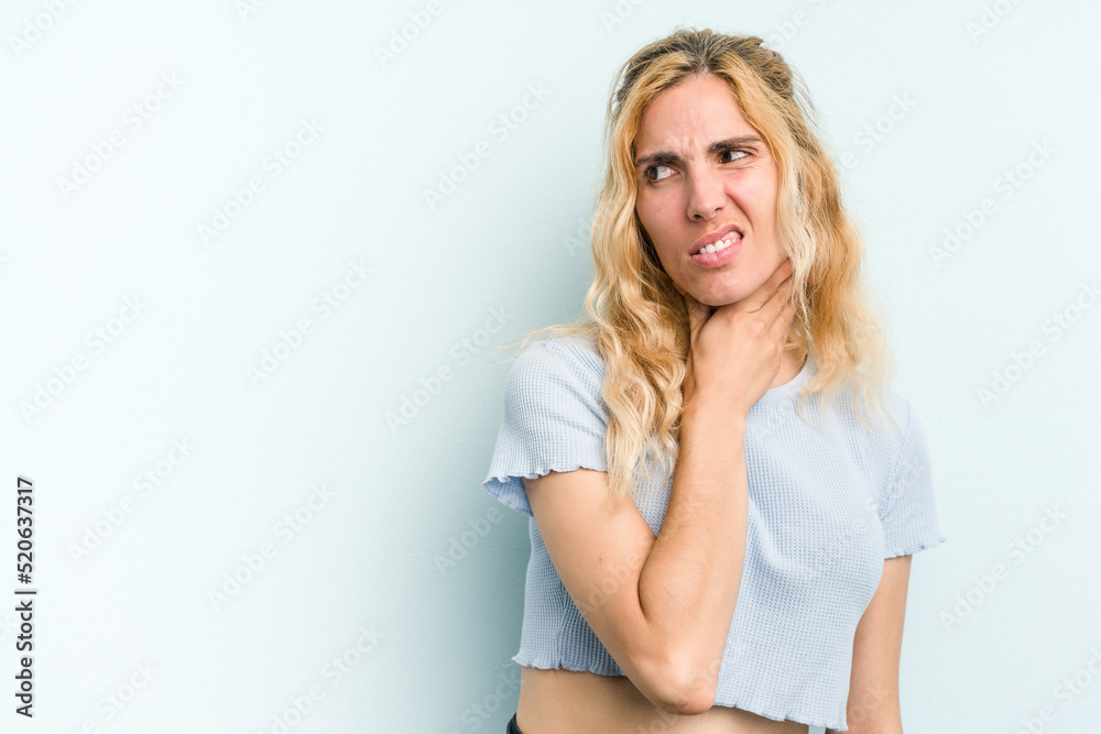Young caucasian woman isolated on blue background touching back of head, thinking and making a choice. Young caucasian woman isolated on blue background touching back of head, thinking and making a choice.