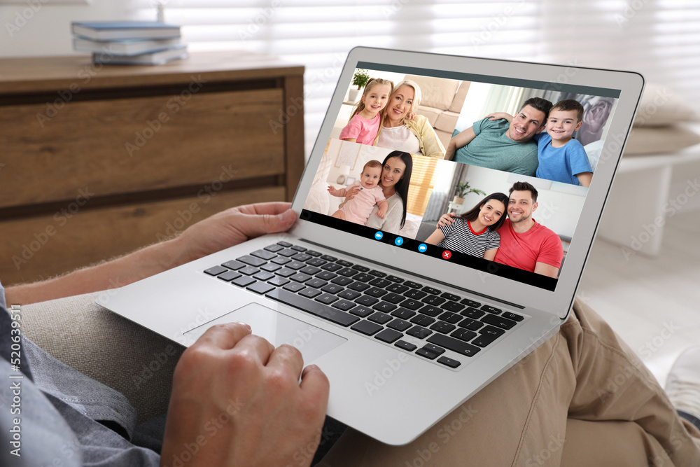 Man having online meeting with family members via videocall application at home, closeup Man having online meeting with family members via videocall application at home, closeup