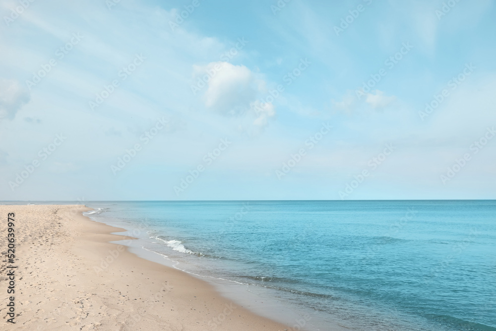Beautiful view of sea shore under blue sky on sunny day