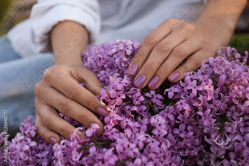 Woman with bunch of beautiful lilac flowers  closeup
